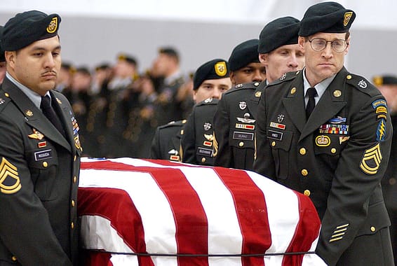 An honor guard from the 1st Special Forces Group transports the flag draped coffin of Sgt. 1st Class Nathan R. Chapman late Tuesday night at Seattle-Tacoma International Airport. More than 60 Special Forces soldiers from Fort Lewis were present.